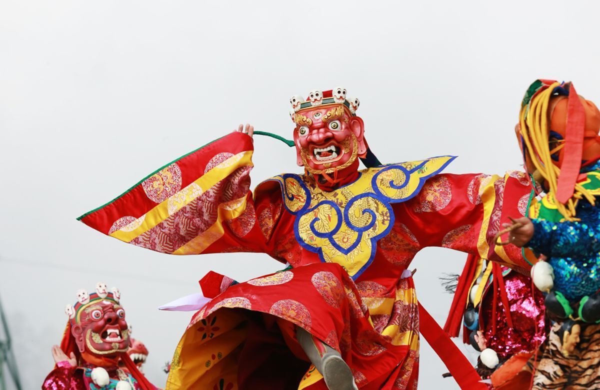 A masked dancer at a tshechu